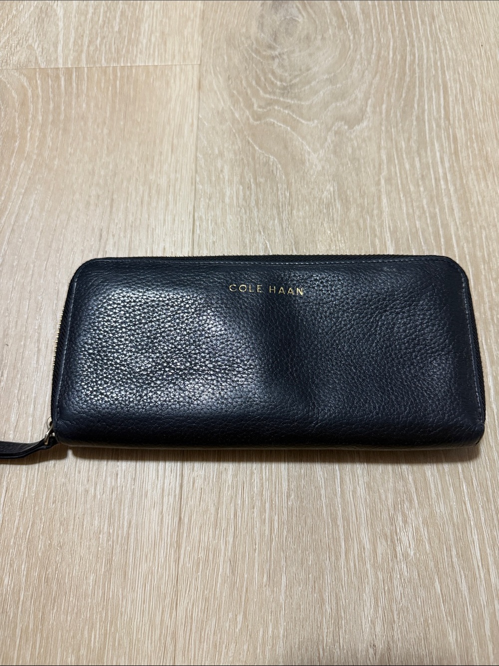 Cole Haan Black Pebbled Leather Zip-Around Wallet with Gold Logo